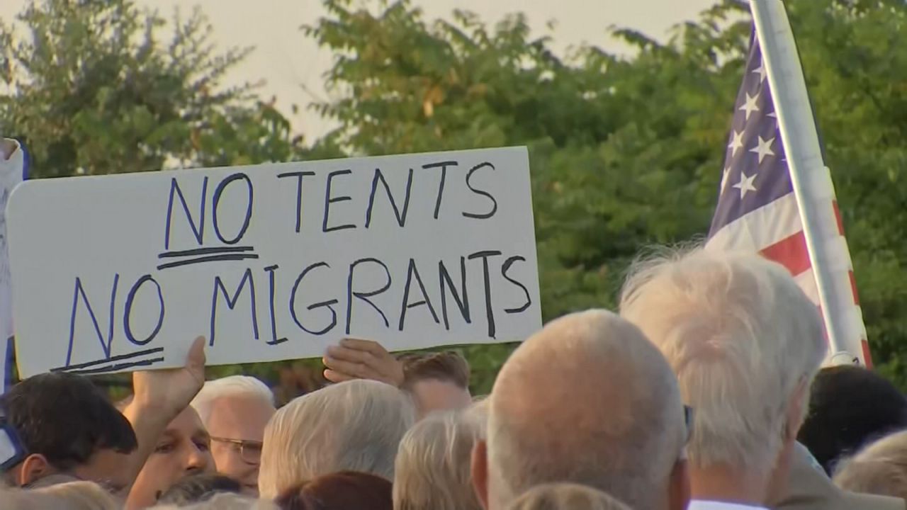 Hundreds protest migrant facility at Floyd Bennett Field